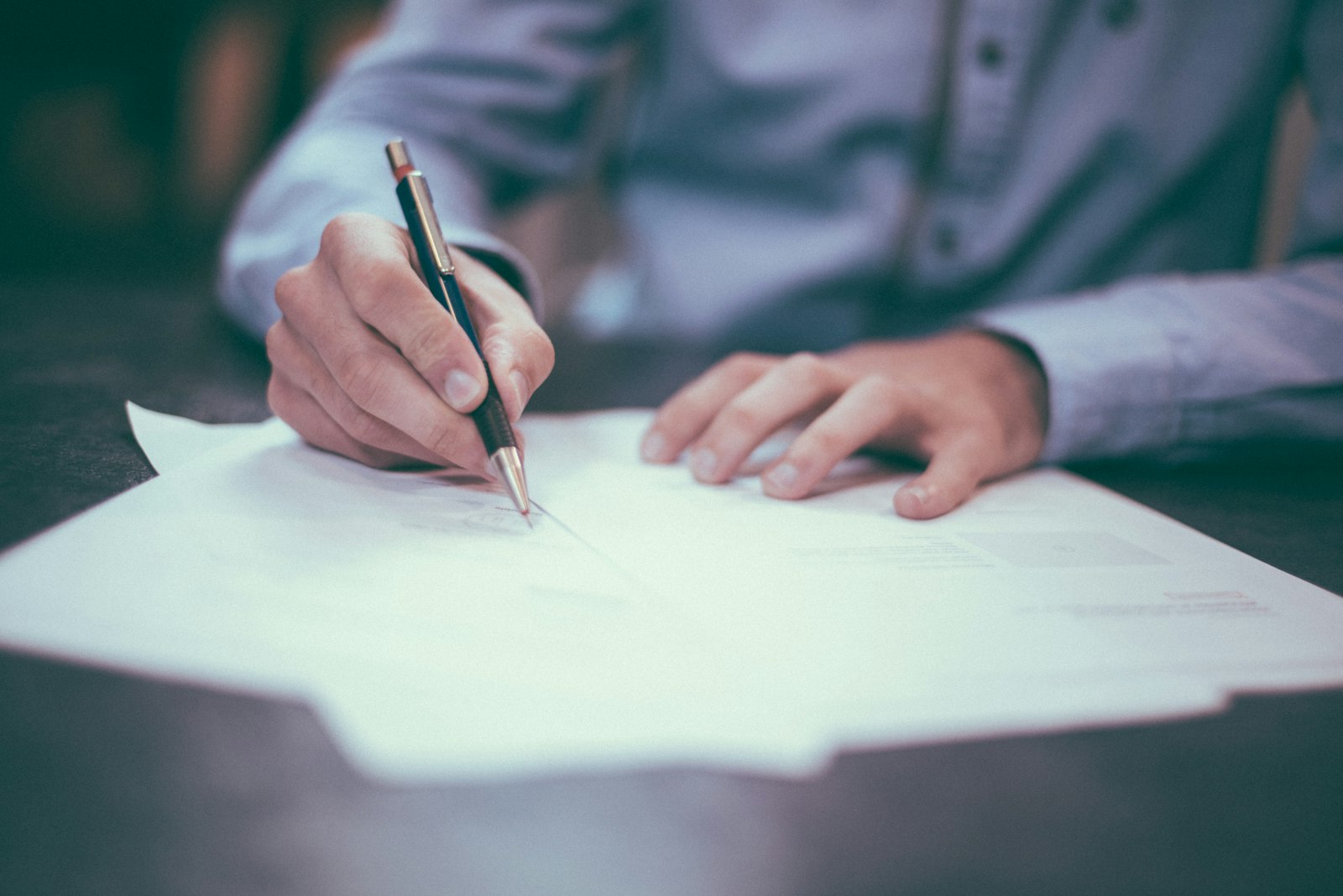 Client reviewing documents at a desk during a consultation