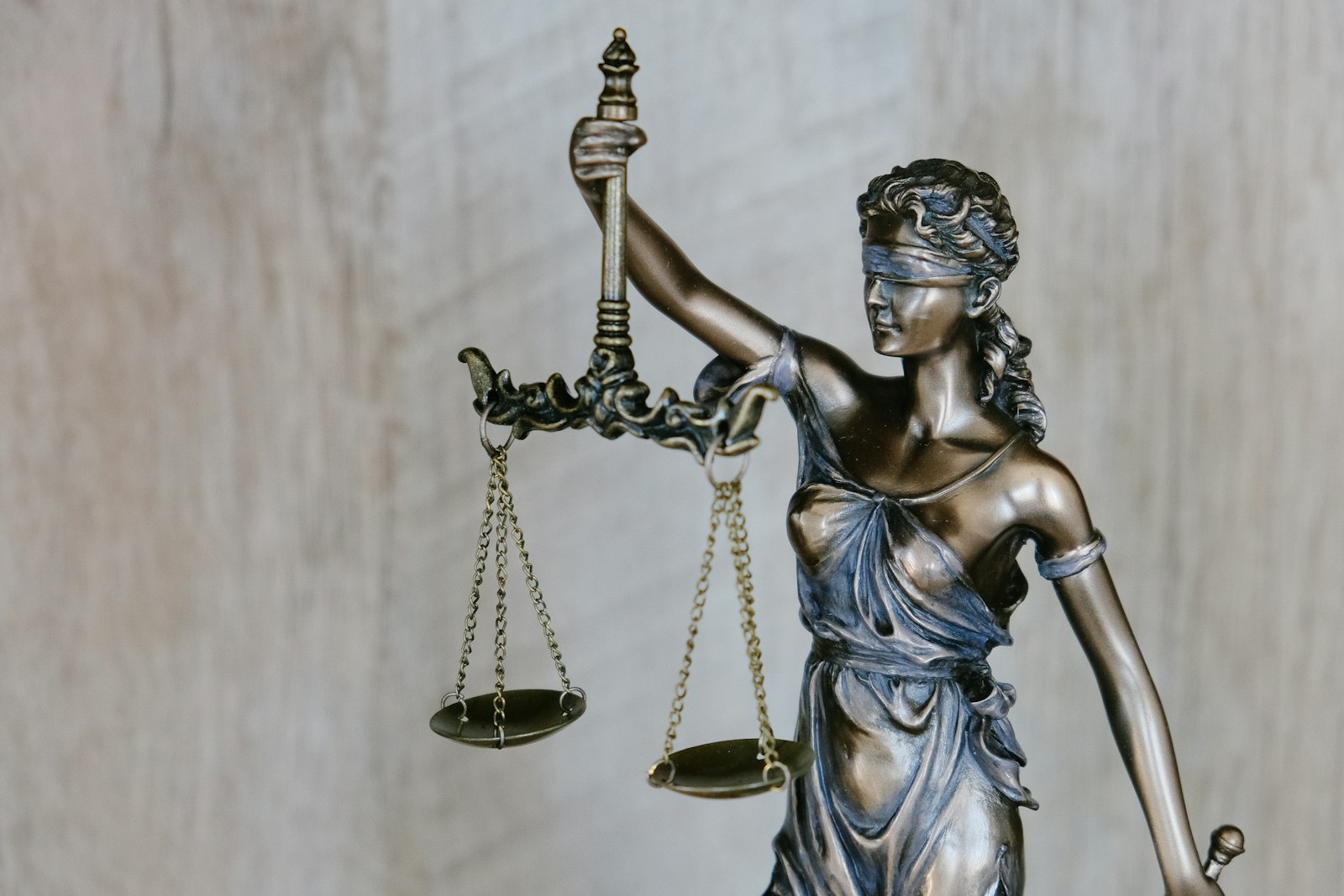 Statue of Lady Justice holding balanced scales
